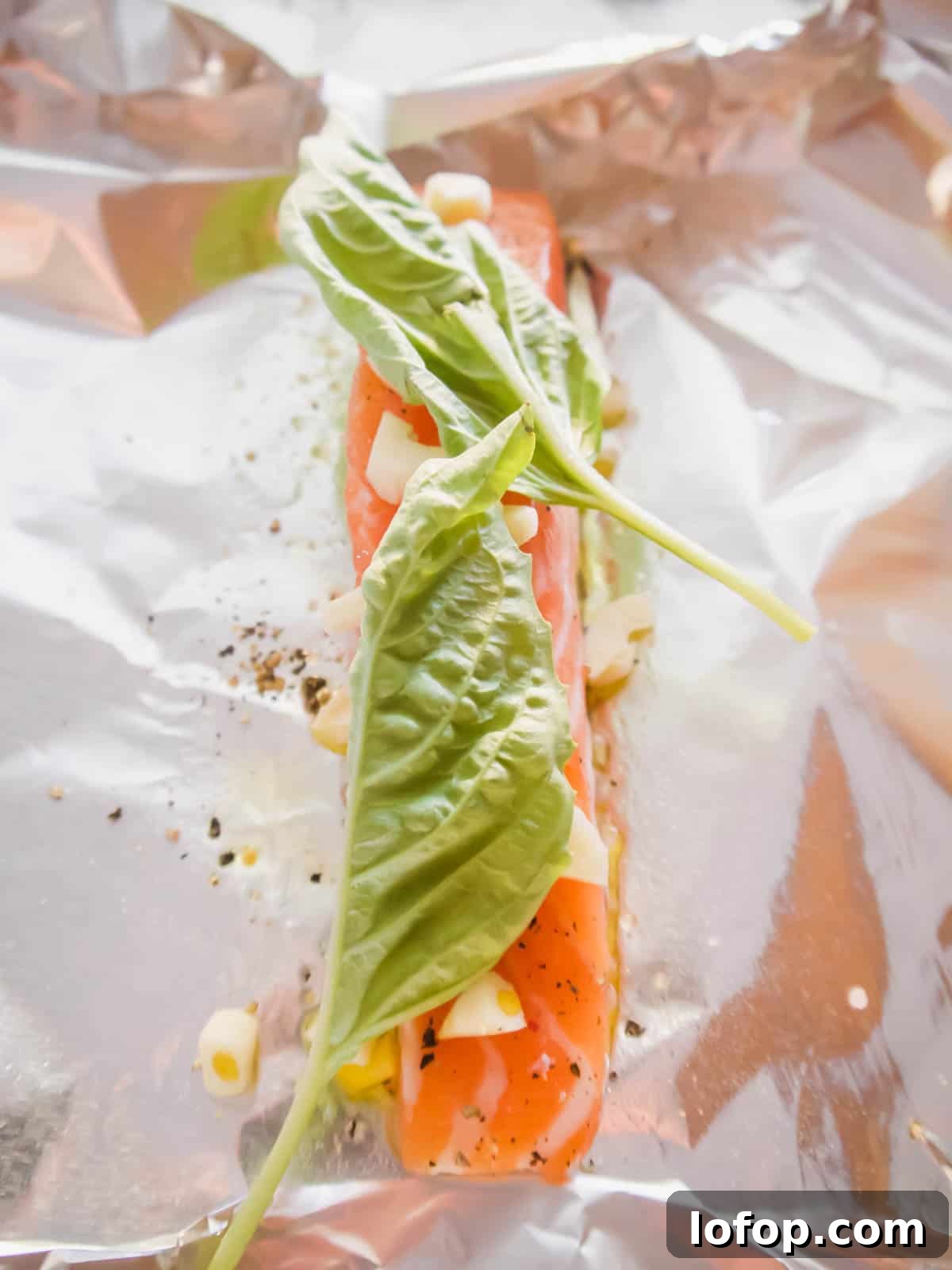 Salmon with garlic and basil on top.