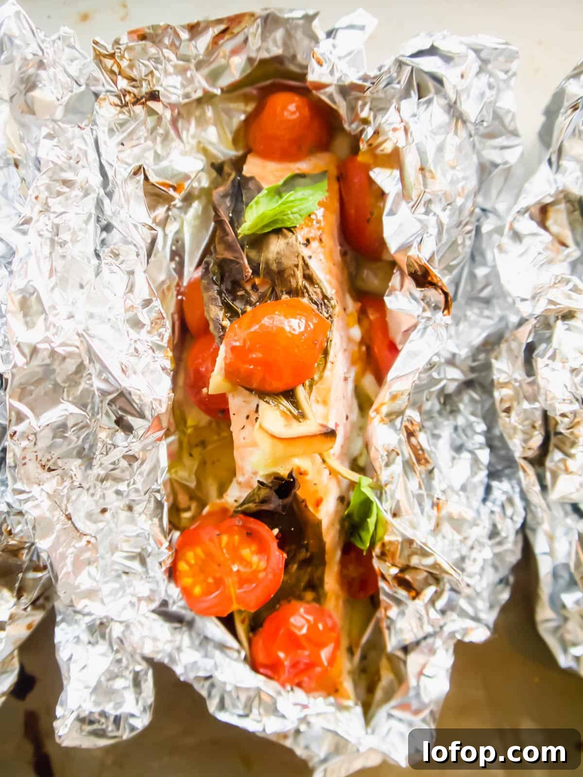 Oven baked salmon foil packets .