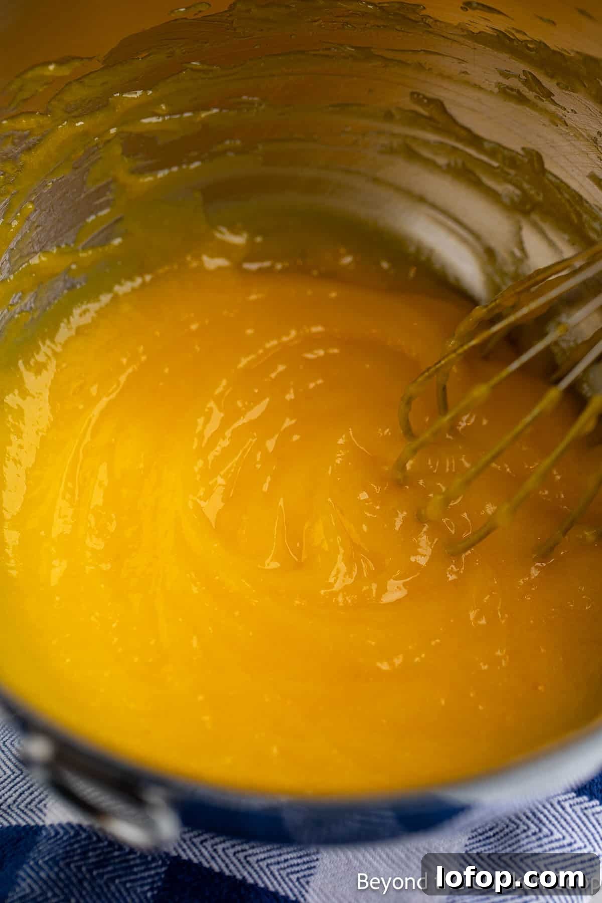 Mini Lemon Tarts Recipe: Zesty Bite-Sized Citrus Pastries 4 Lemon curd in a metal bowl.
