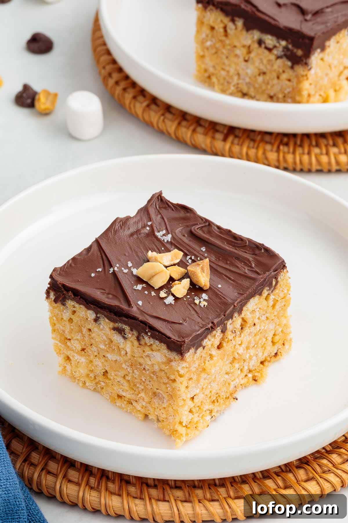 Chocolate Peanut Butter Rice Krispie Treat Recipe 2 A peanut butter Rice Krispie treat topped with a smooth layer of chocolate, chopped peanuts, and a sprinkle of flaky salt.