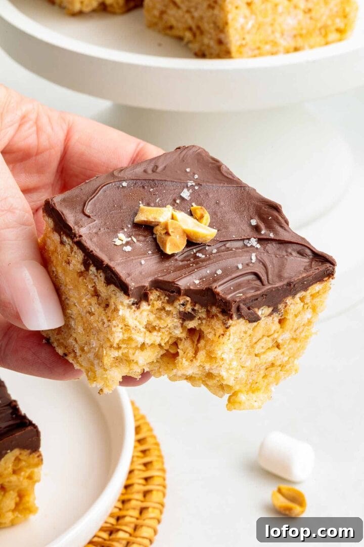 Chocolate Peanut Butter Rice Krispie Treat Recipe 11 A bite taken out of a chocolate peanut butter Rice Krispie treat.