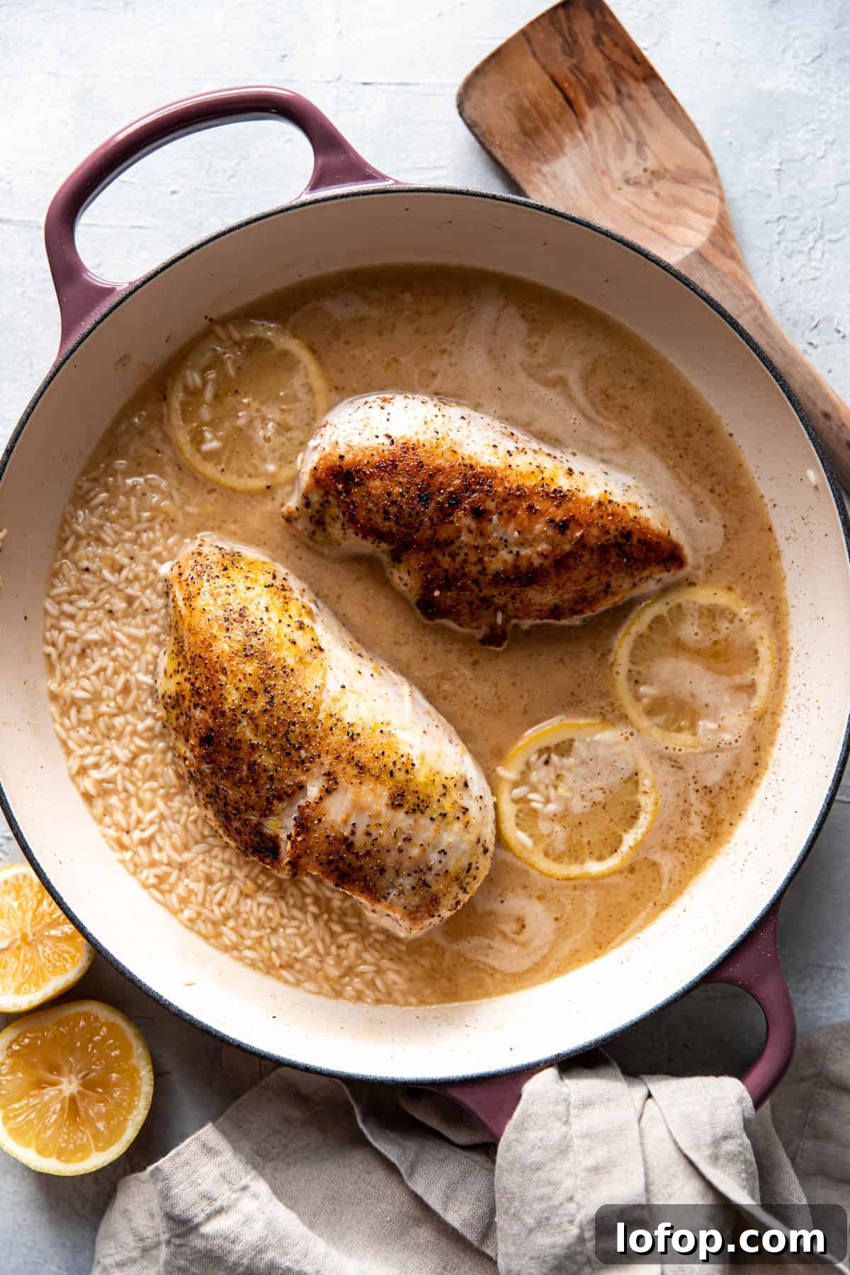 lemon chicken and rice in a pan before being cooked.