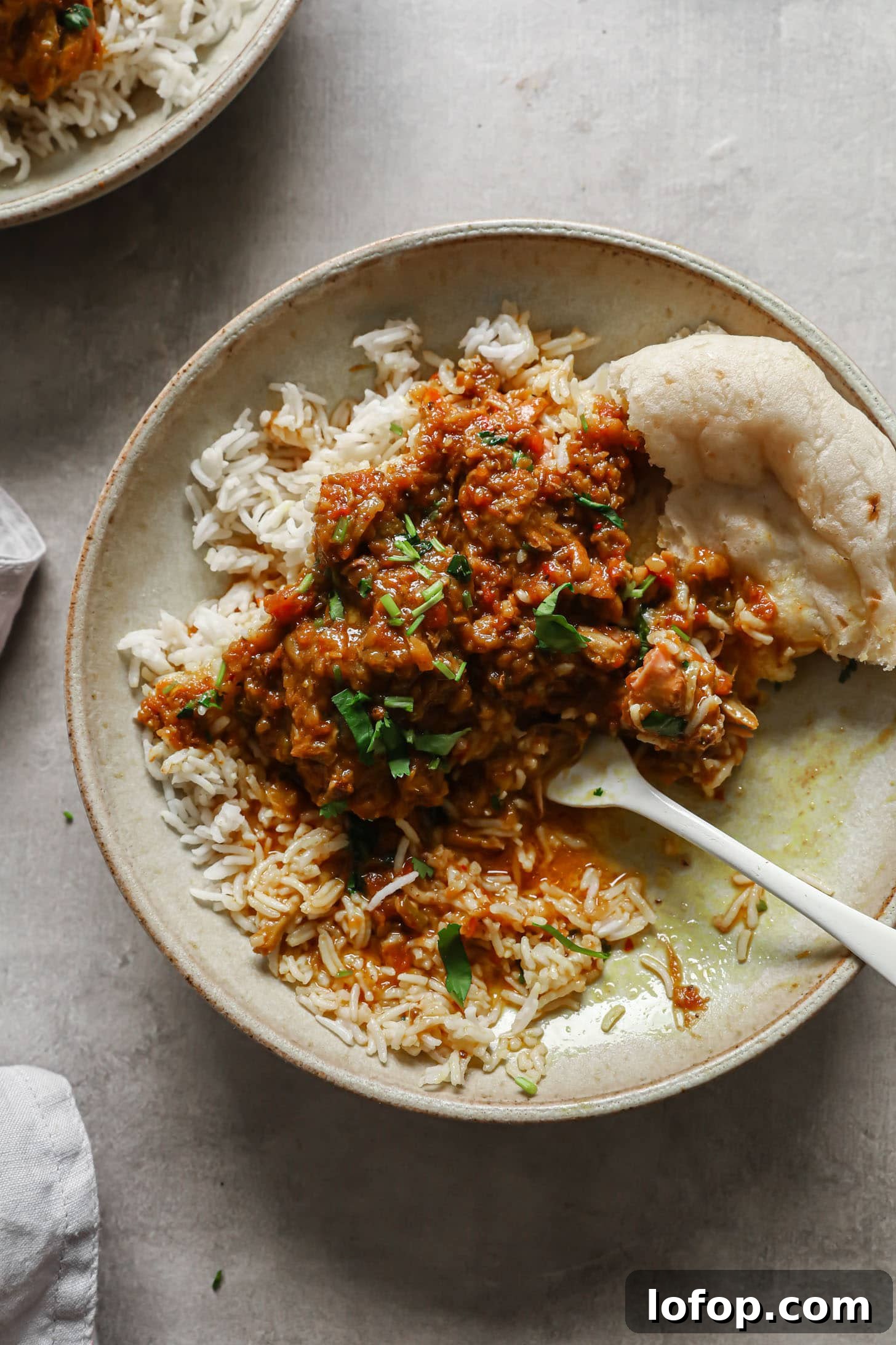 A rustic half-eaten chicken curry 