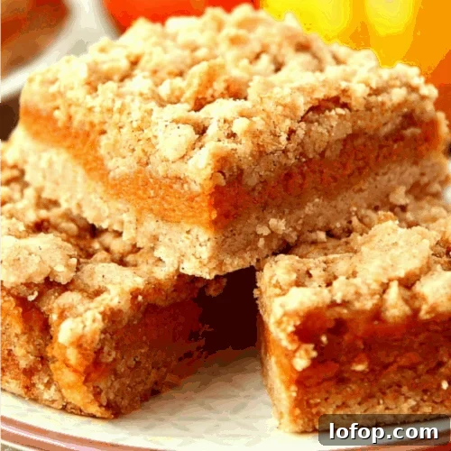 Pumpkin pie bars stacked on plate.