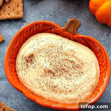 Creamy Pumpkin Cheesecake Dip Recipe for Fall Entertaining 2 Pumpkin cheesecake dip in orange pumpkin bowl.