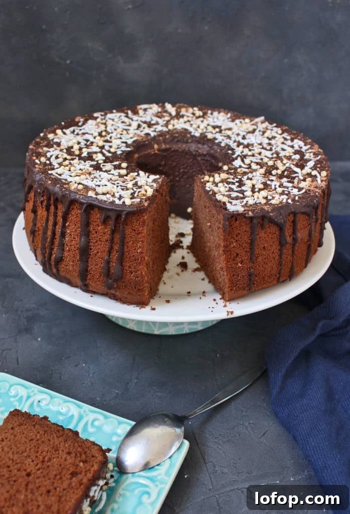 Chiffon cake on a cake stand with a slice cut off