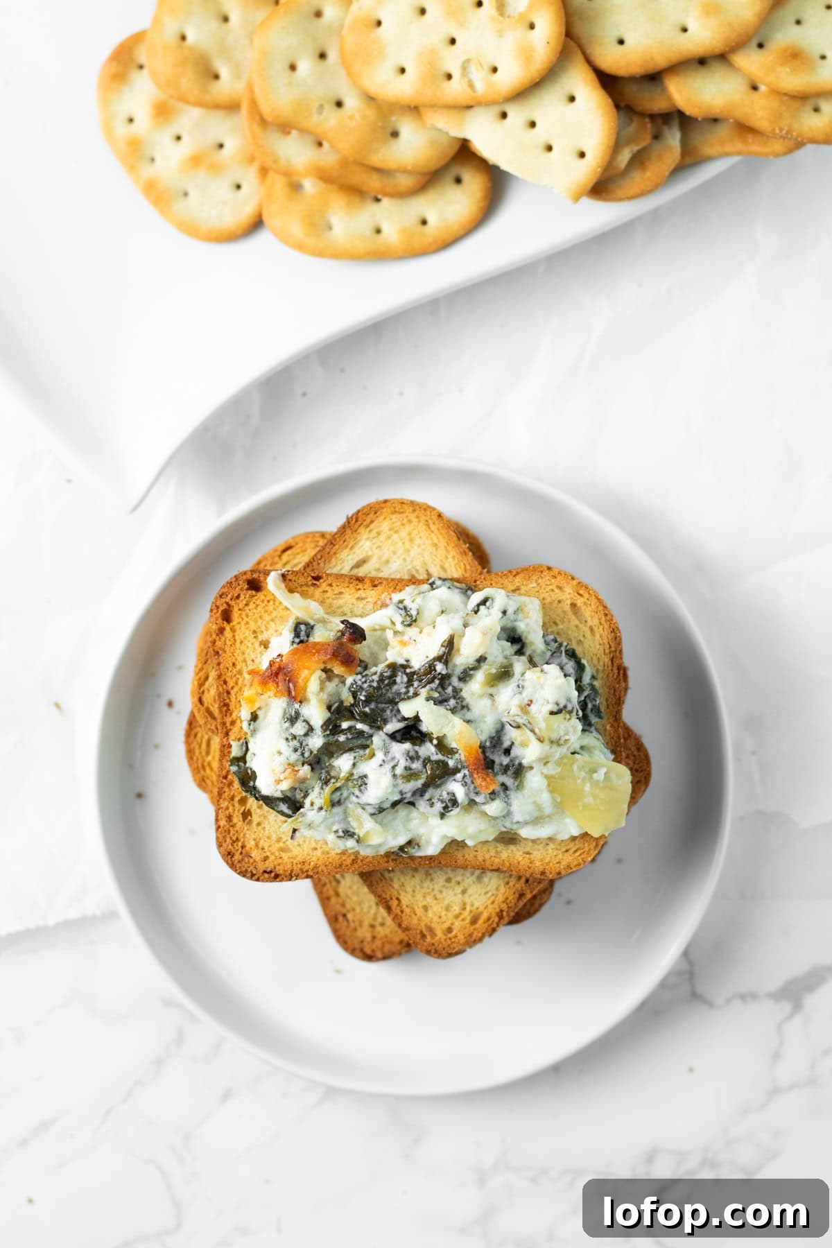 spinach artichoke dip on a piece of crostini.
