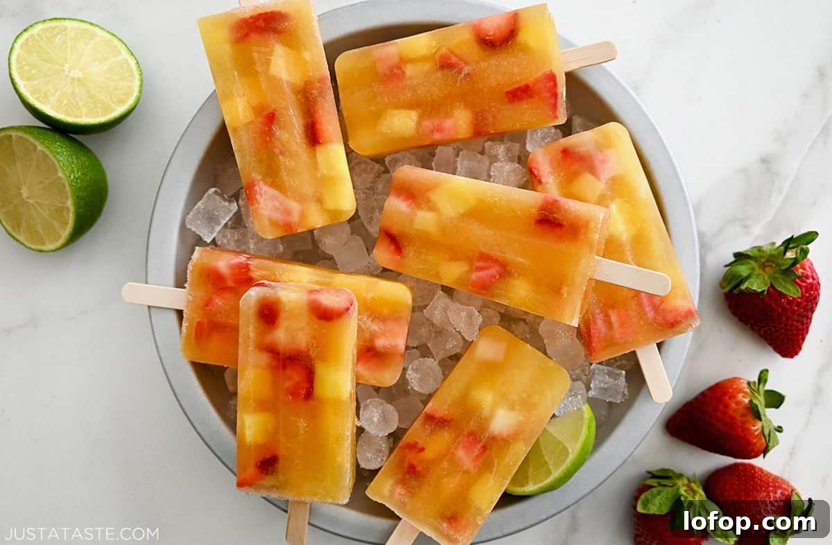 Peach Sangria Popsicles Recipe: Refreshing Boozy Summer Treat 7 Peach sangria popsicles in a bowl filled with ice.