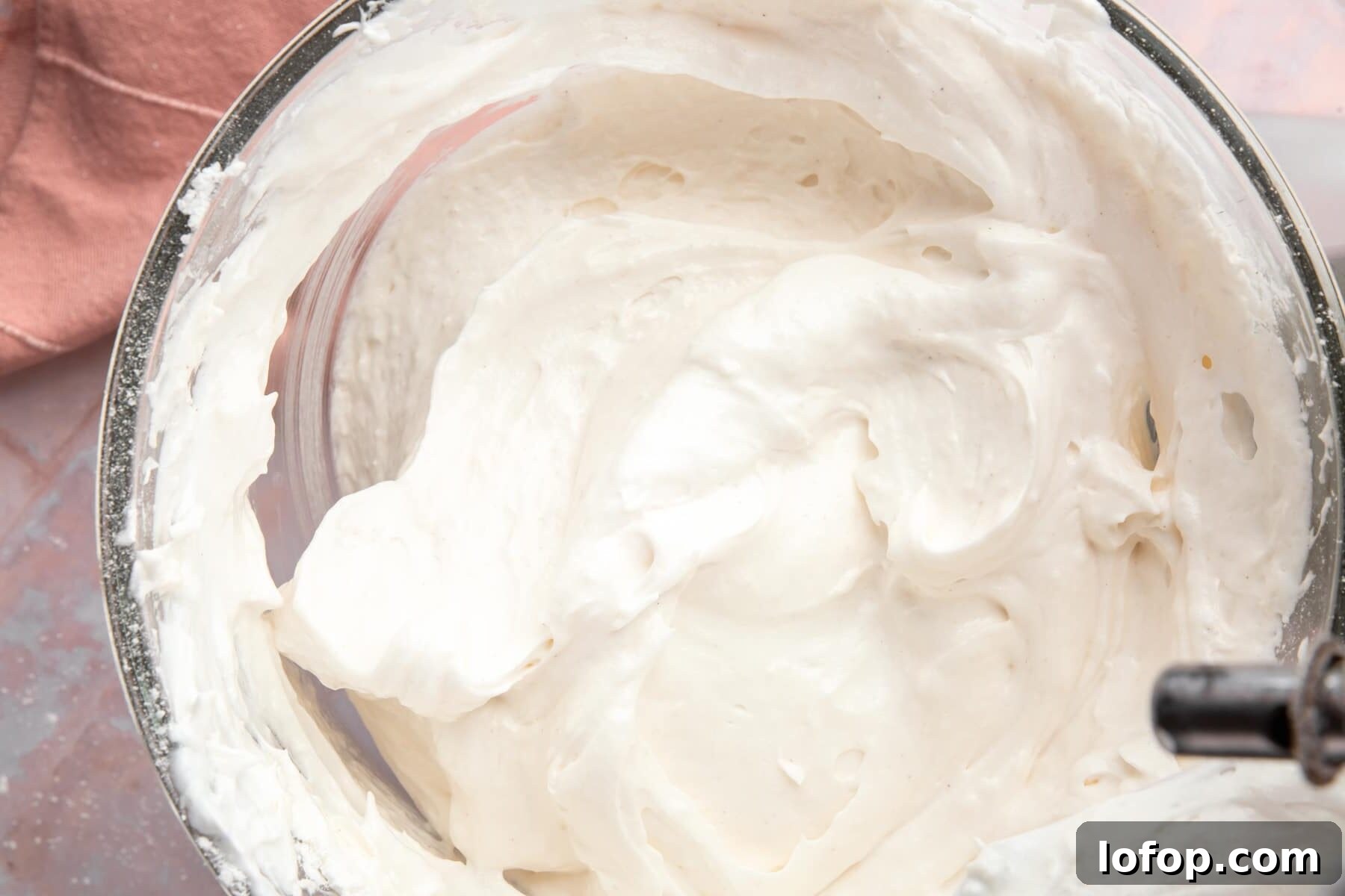 Raw angel food cake batter in a glass mixing bowl.