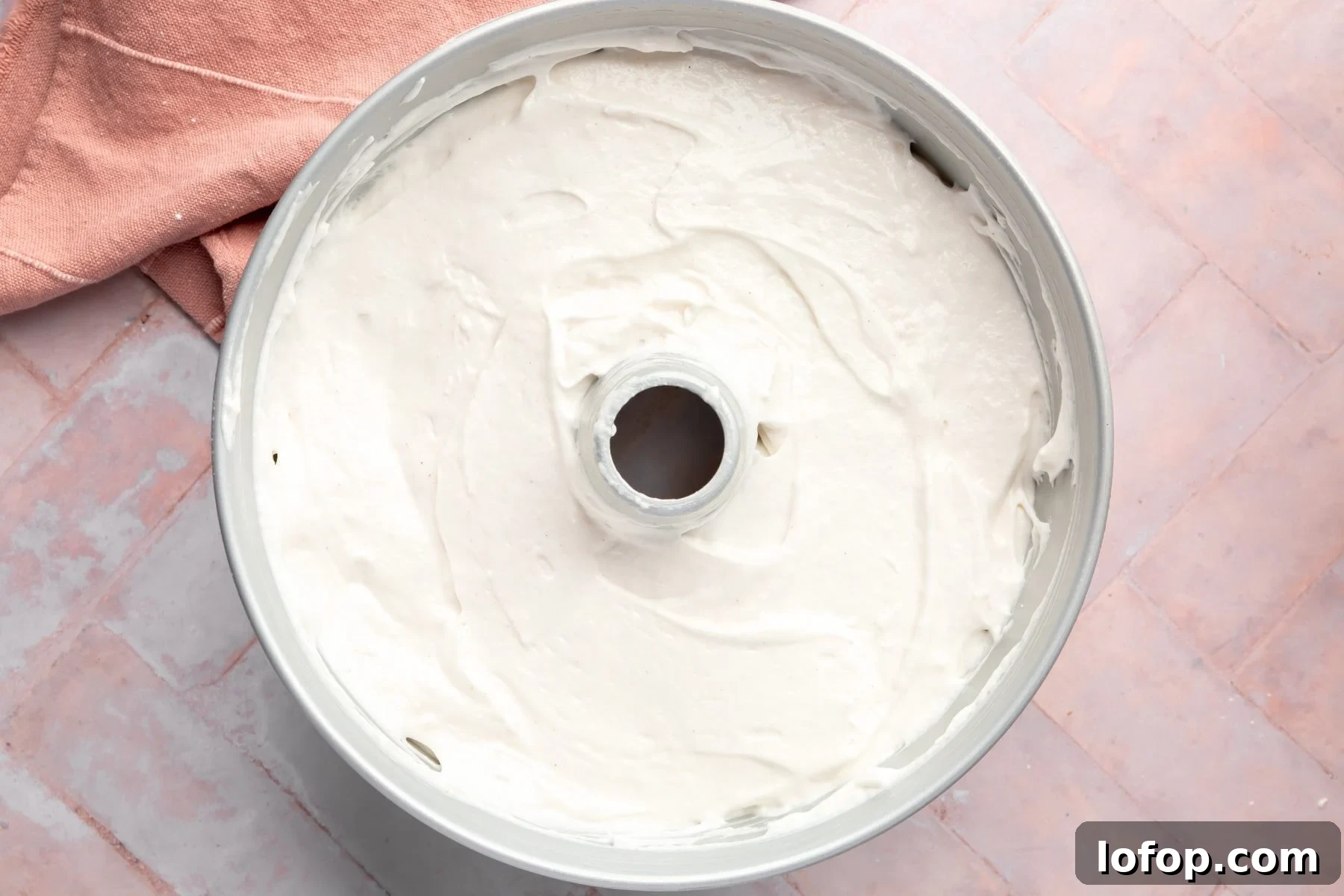 Raw angel food cake batter in a tube pan.