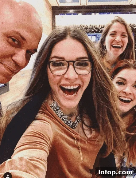 a "selfie" with three long haired smiling women and a bald man