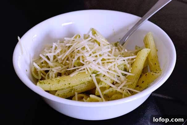 Creamy Pesto Pasta Salad Made with Store-Bought Pesto 8 creamy pesto pasta in a salad bowl topped with Parmesan cheese