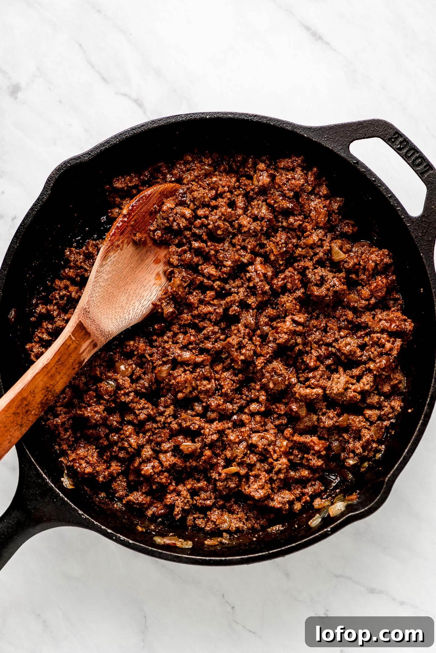 Crispy Dorito Taco Salad Recipe for Game Day and Weeknight Meals 8 Ground taco meat in a cast iron skillet.