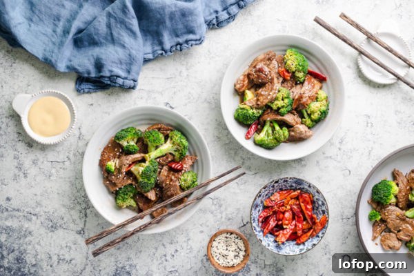 Keto-Style Beef and Broccoli Stir-Fry Recipe 4 Keto beef and broccoli with dried red peppers in bowls with chopsticks and Chinese mustard.