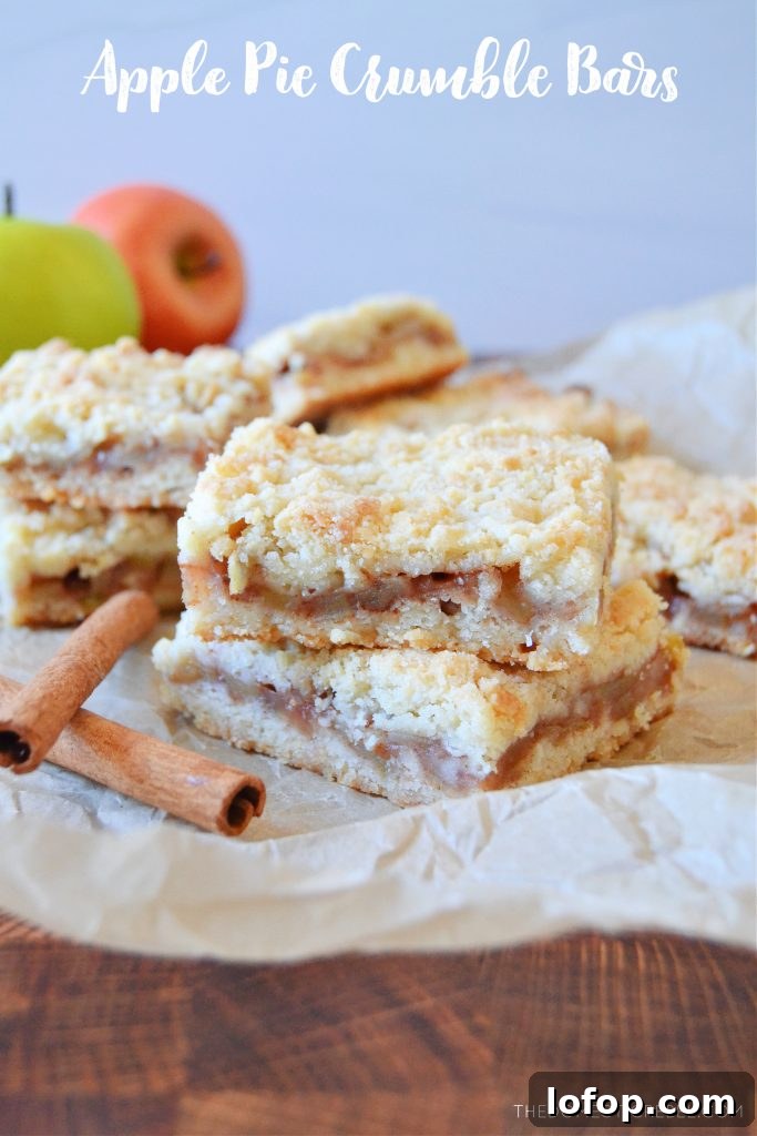 Apple Crumble Bars with Cinnamon Streusel 2 a double stack of apple pie crumble bars on parchment with cinnamon sticks