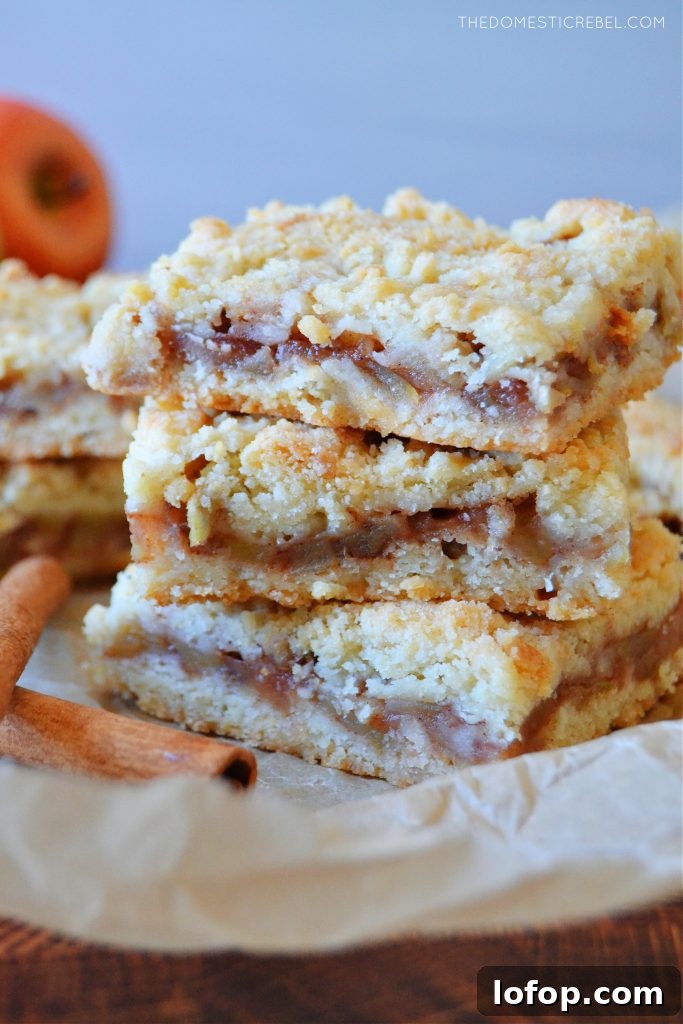 Apple Crumble Bars with Cinnamon Streusel 3 a triple stack tower of apple pie crumble bars on brown parchment
