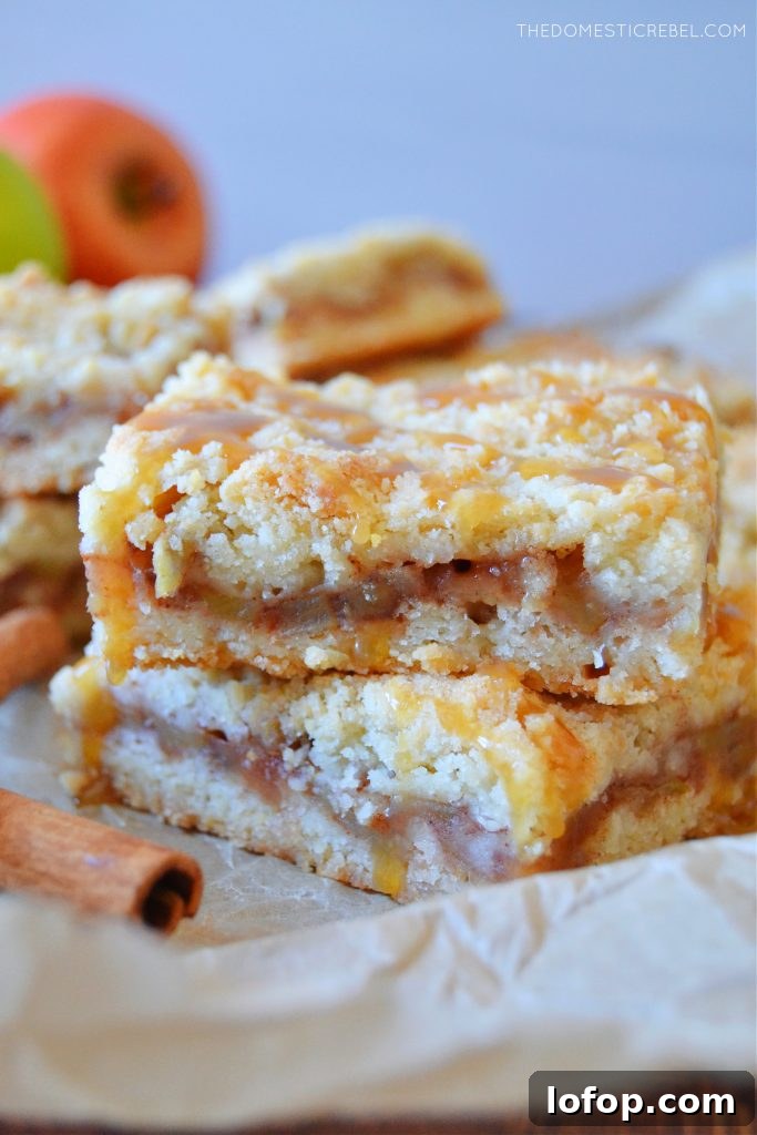 Apple Crumble Bars with Cinnamon Streusel 4 a double stack of apple pie crumble bars drizzled with caramel sauce