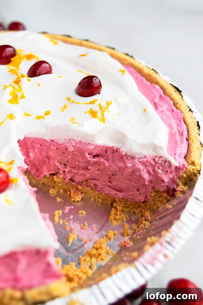 No-Bake Cranberry Pie Recipe — Fresh & Simple Holiday Dessert 4 Closeup Shot of Easy Cranberry Pie in Graham Cracker Crust and Whipped Cream Topping on a White Background