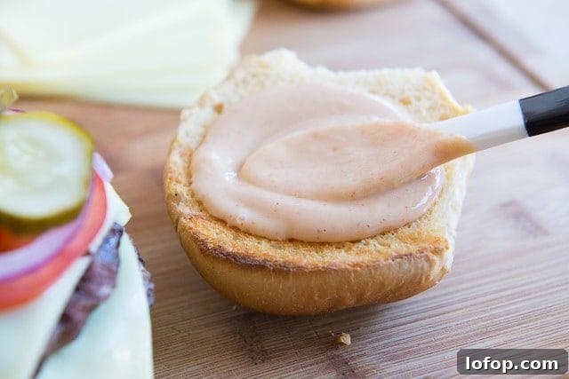 Double Decker Burger Recipe: How to Build a Juicy Stacked Burger 12 Spreading Burger Sauce on Top Bun with Spoon