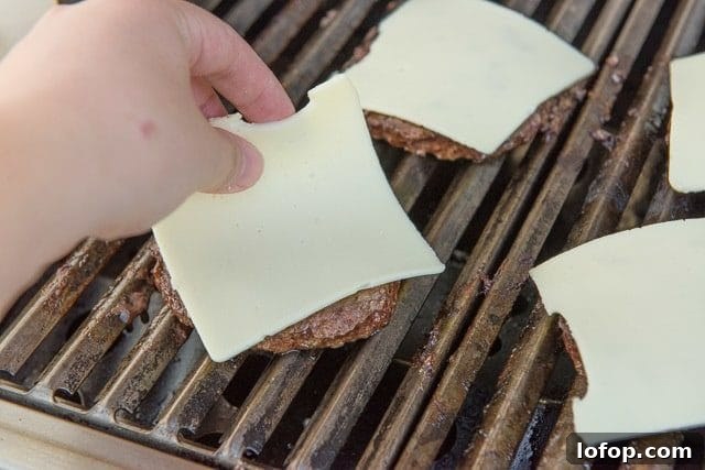 Double Decker Burger Recipe: How to Build a Juicy Stacked Burger 7 Adding Slices of Cheese to Grilled Beef Patties