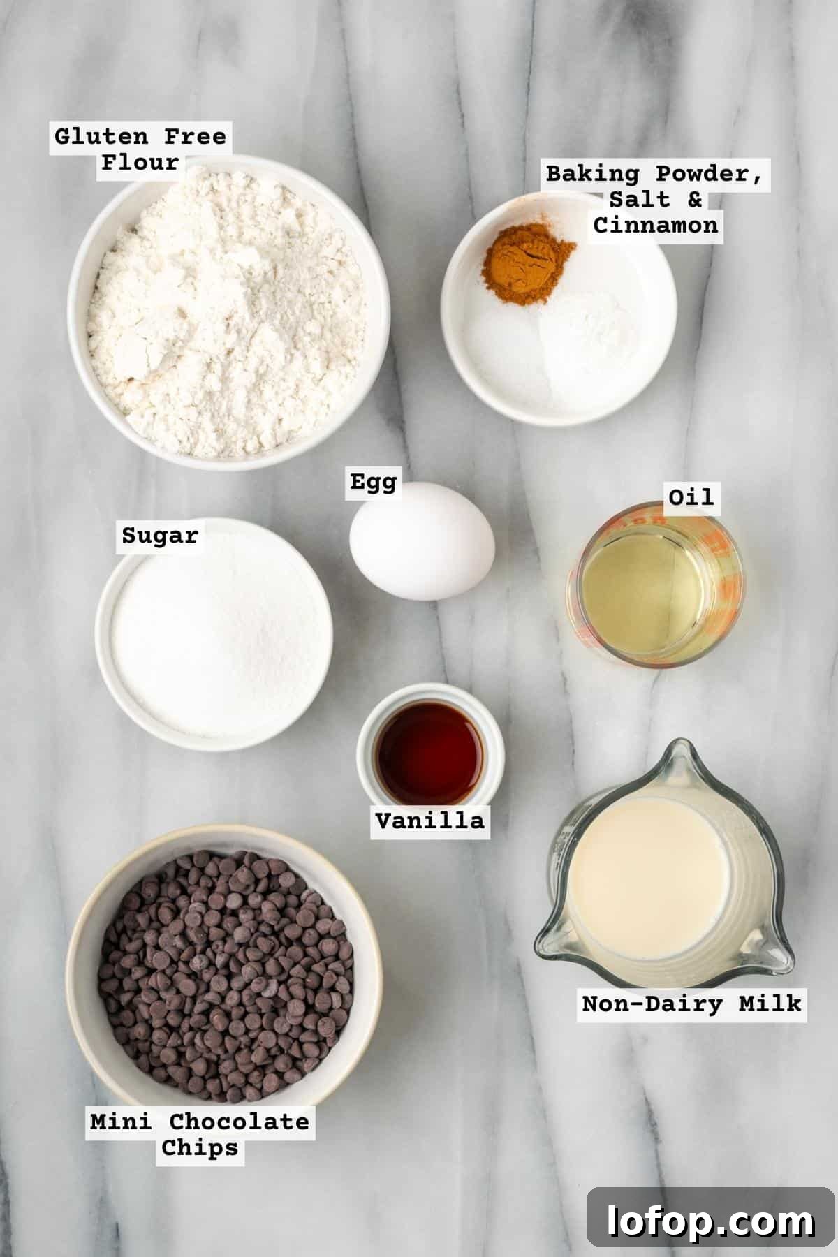 Ingredients for gluten free chocolate chip muffins on a marble countertop.