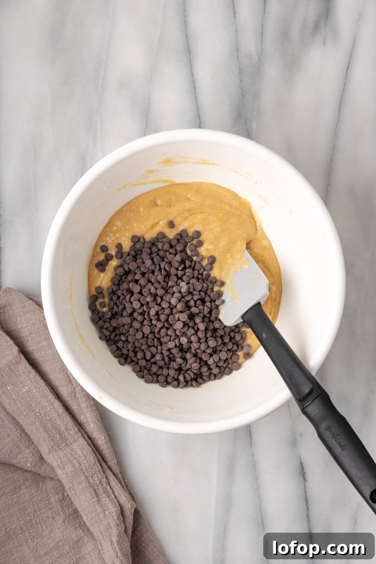 Mini chocolate chips added to the gluten free muffin batter.