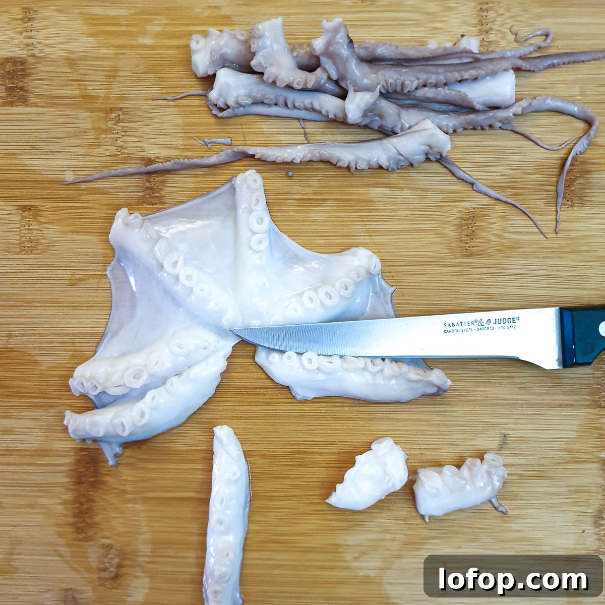An octopus being cut into pieces.
