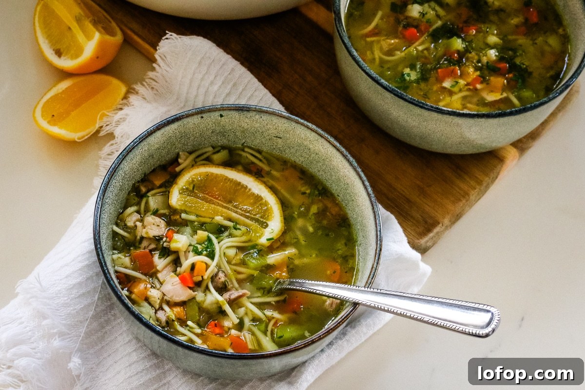 Romanian ciorbă soup served in a white pot and a white bowl.