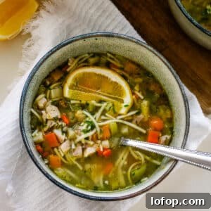 Romanian ciorbă soup served in a bowl with a spoon.