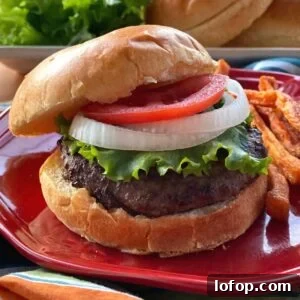 Wagyu Beef Burger on a brioche bun topped with lettuce, onion, and tomato.