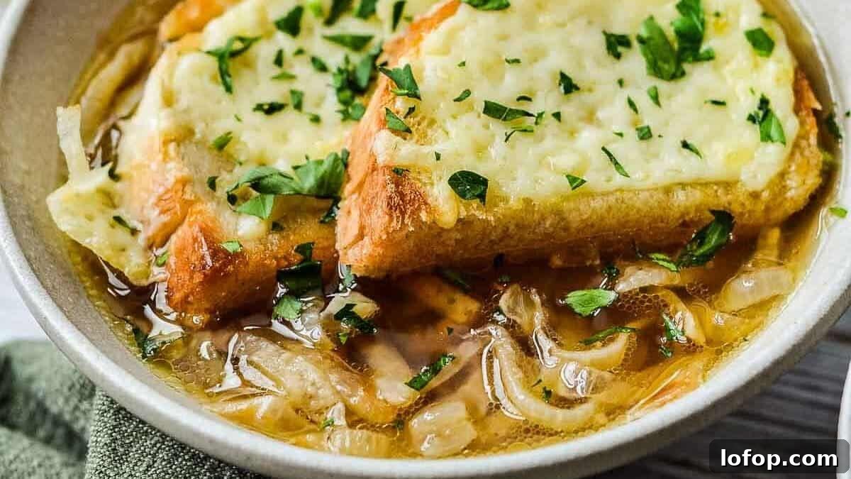 12 Flavor-Packed Meatless Dinners You’ll Love Tonight 12 A bowl of French onion soup topped with melted cheese and chopped parsley on toasted bread, with a spoon in the bowl.