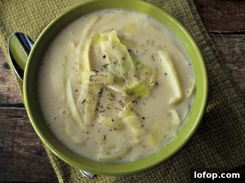 12 Flavor-Packed Meatless Dinners You’ll Love Tonight 3 Colcannon Soup in a green bowl with a spoon.
