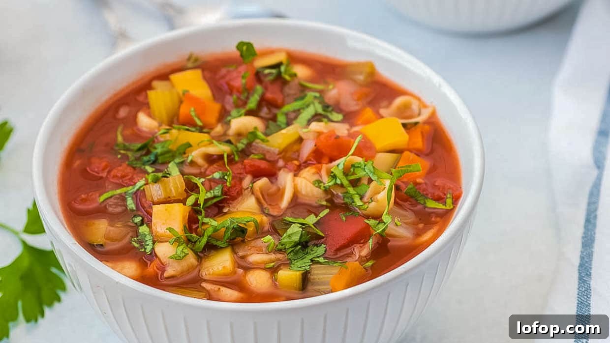 12 Flavor-Packed Meatless Dinners You’ll Love Tonight 4 Olive Garden Minestrone Soup in a white bowl topped with basil.
