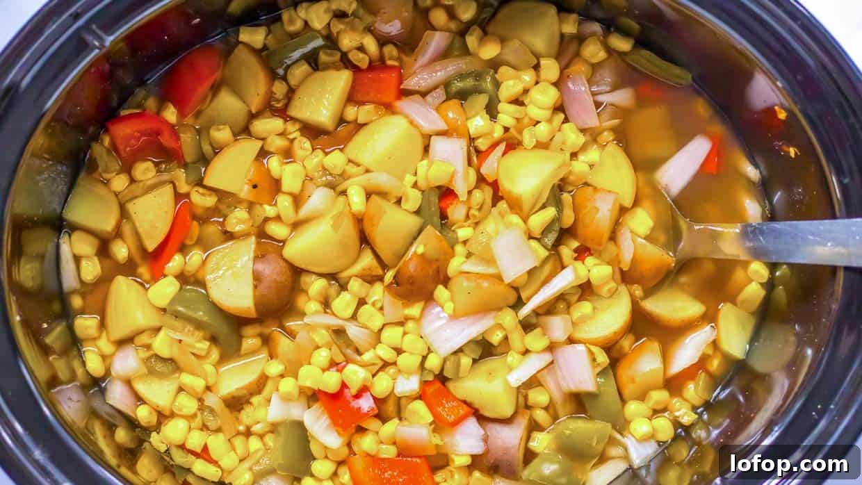 12 Flavor-Packed Meatless Dinners You’ll Love Tonight 7 Street corn soup with potatoes, corn and red pepper in the crock pot with a spoon on the side.