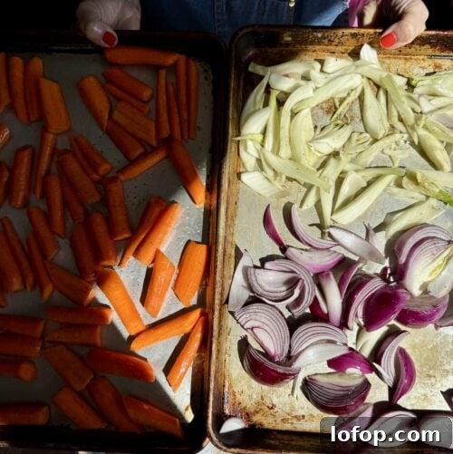 a sheet pan with carrots next to a sheet pan with fennel and red onions