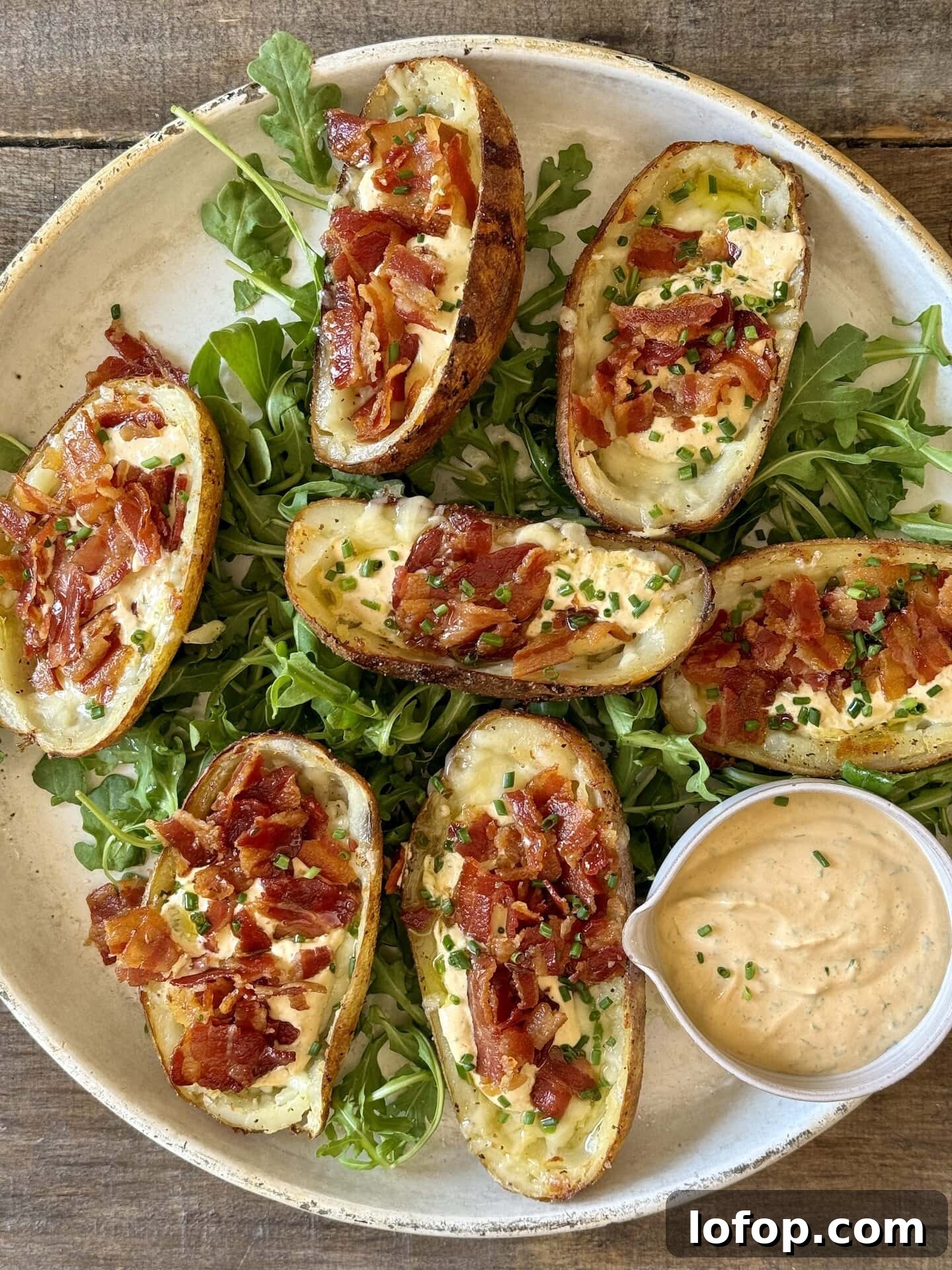 an above view photo of loaded potato skins on a white plate