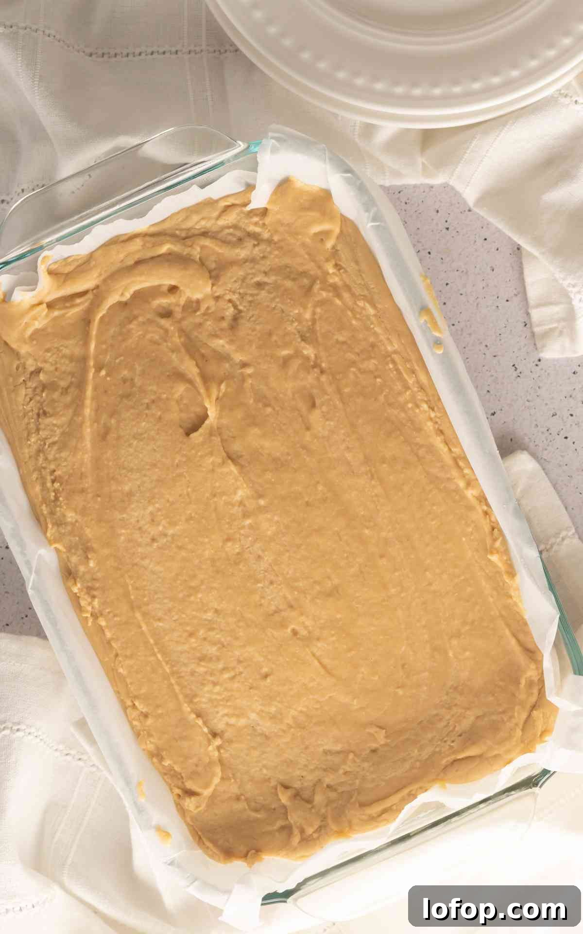Creamy Peanut Butter Fudge Recipe for Rich Homemade Candy 3 A glass dish with chilled peanut butter fudge in it.