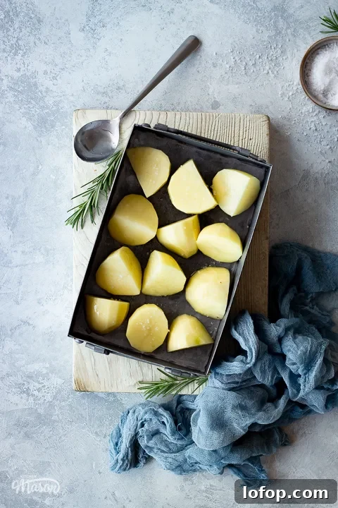A roasting tray with prepared potatoes