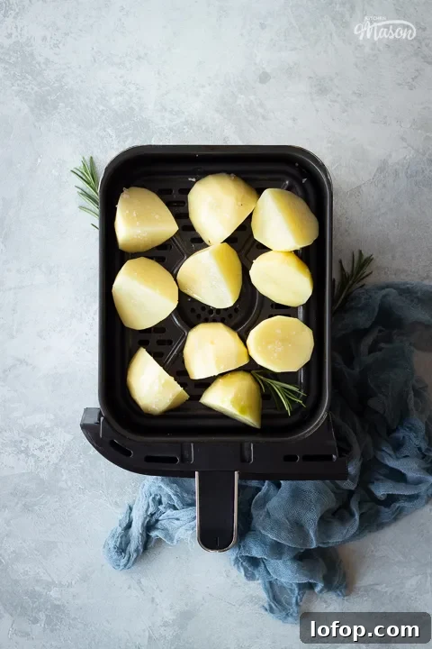Prepped potatoes in an air fryer drawer