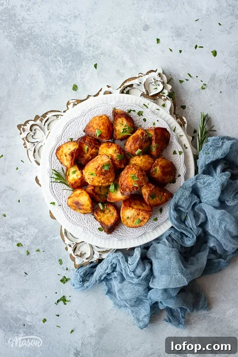 A plate of air fryer roast potatoes scattered with parsley