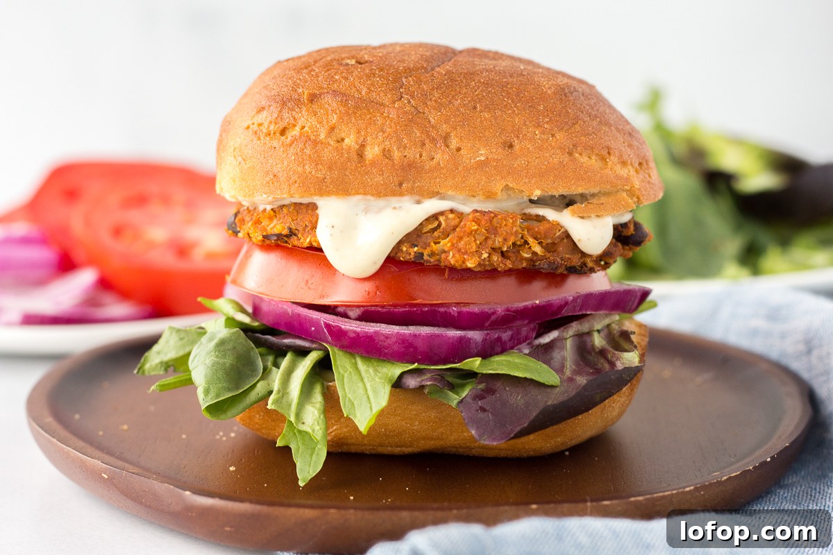 Sweet Potato and Black Bean Burger Recipe for Flavorful Veggie Meals 10 Sweet Potato Black Bean Burgers served on plate with tomato and lettuce in the background