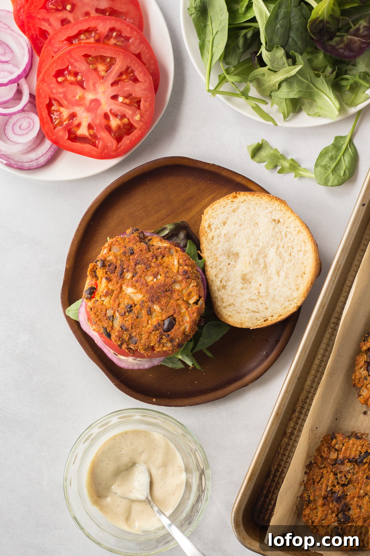 Sweet Potato and Black Bean Burger Recipe for Flavorful Veggie Meals 8 Sweet Potato Black Bean Burgers served on bun on plate with lettuce, tomato, and red onion