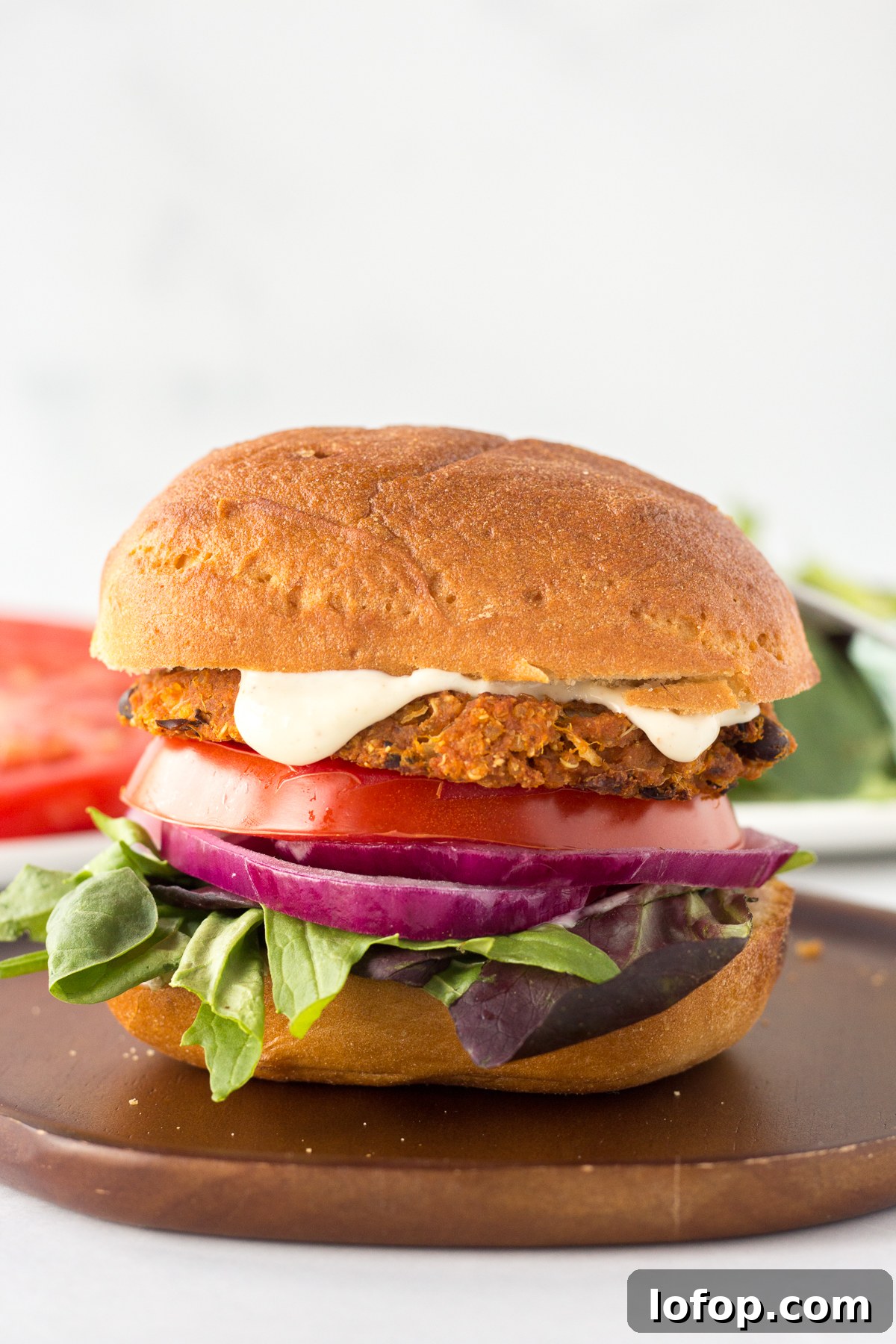 Sweet Potato and Black Bean Burger Recipe for Flavorful Veggie Meals 9 Sweet Potato Black Bean Burgers served on plate with tomato and lettuce in the background