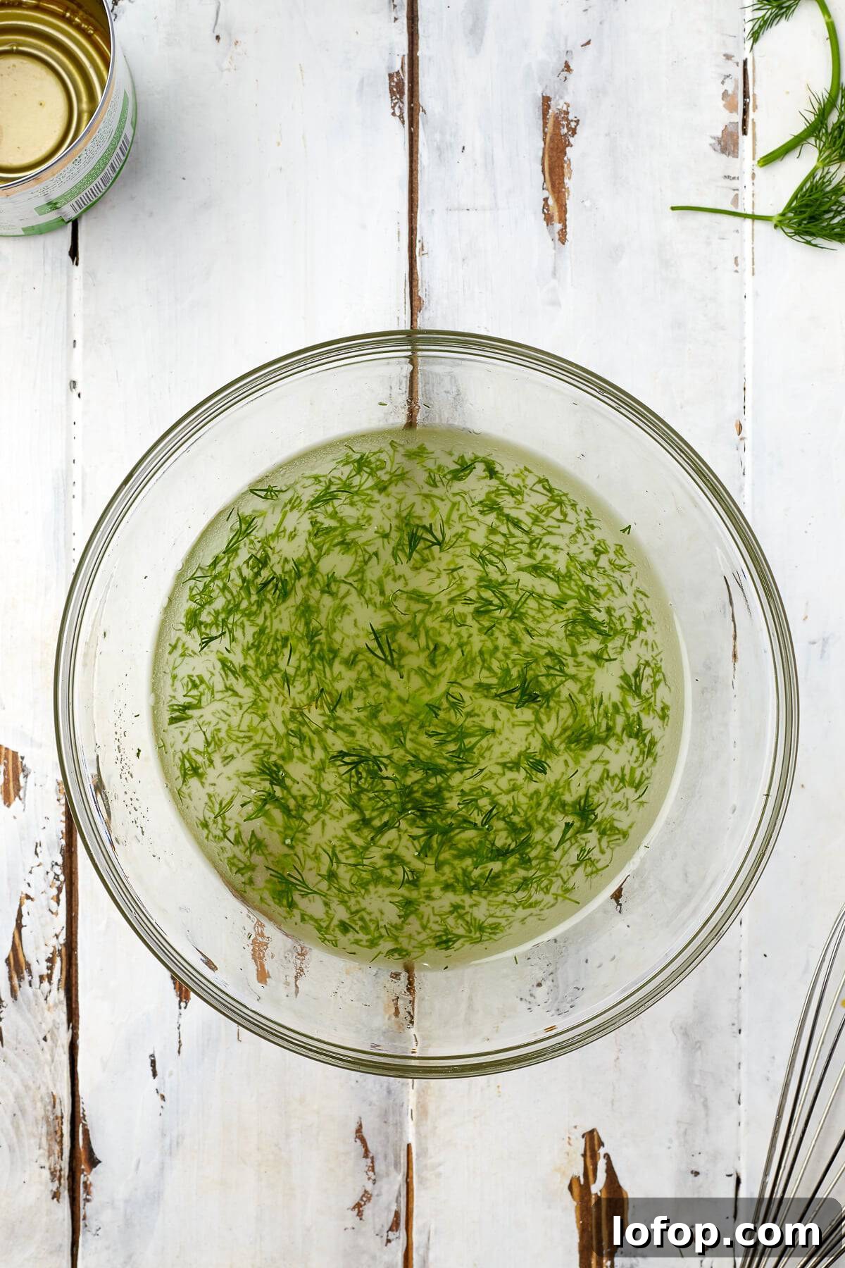 Creamy Vinaigrette Five-Bean Salad Recipe 5 Vinegar, oil, sugar, and fresh dill whisked into a vinaigrette dressing in a glass bowl.