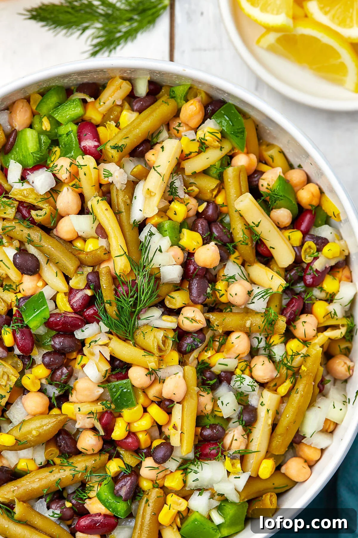 Creamy Vinaigrette Five-Bean Salad Recipe 7 Finished 5 bean salad chilled and ready to serve in a white bowl.