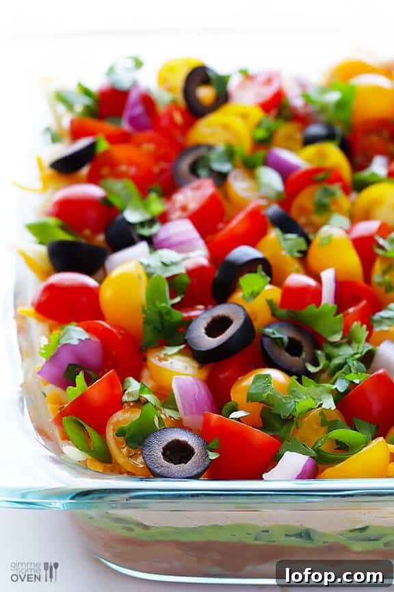 7 Layer Dip -- a fresh recipe for this classic dip that's always a crowd-pleaser! | gimmesomeoven.com #appetizer #gameday