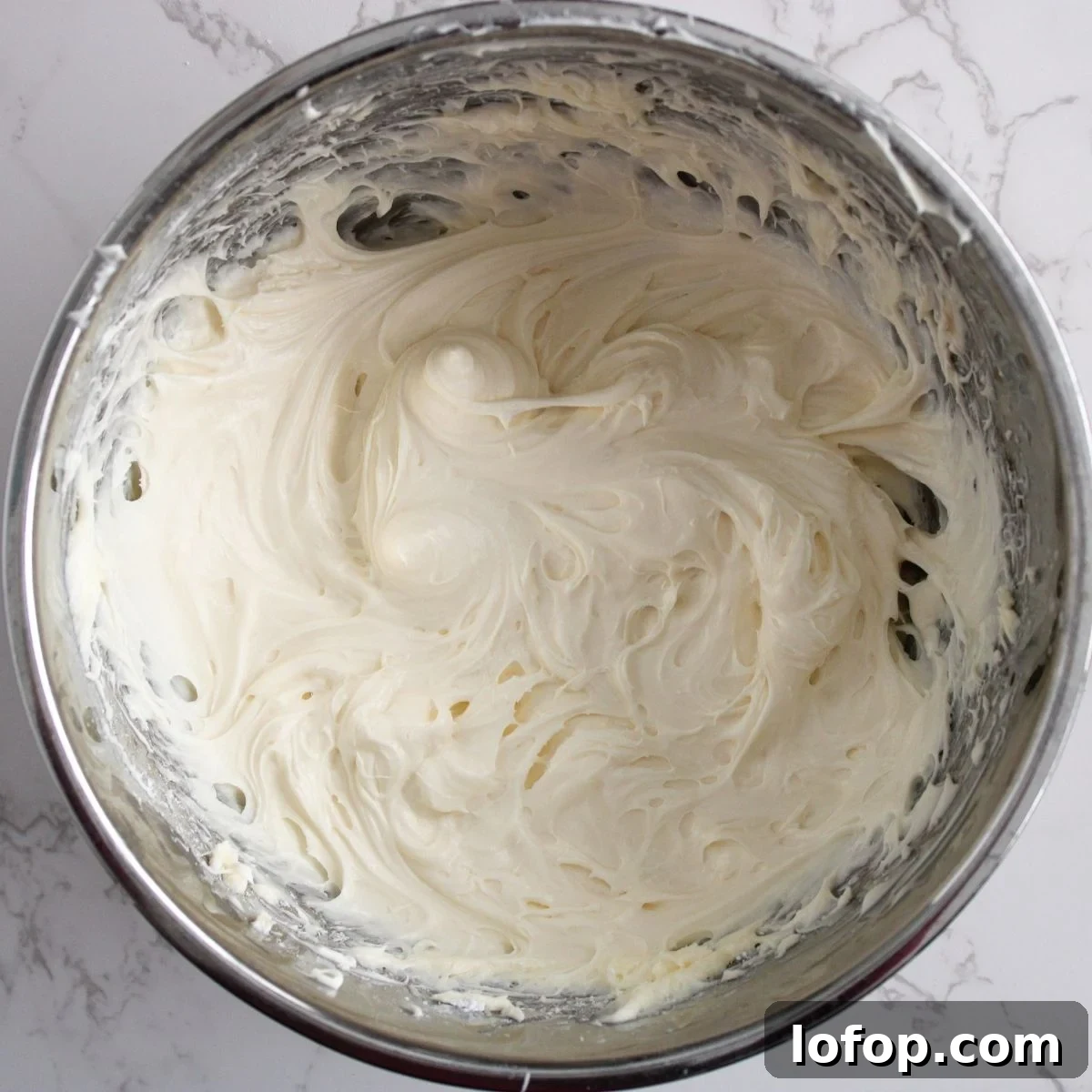 Cream cheese frosting in a bowl.