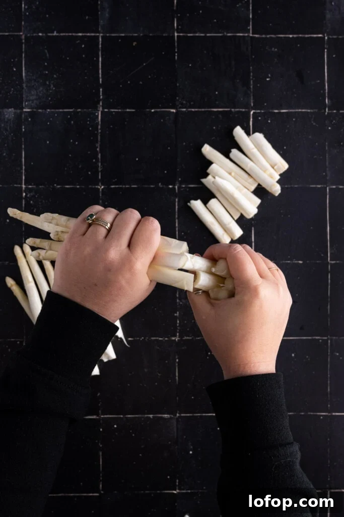 Breaking woody ends off of white asparagus