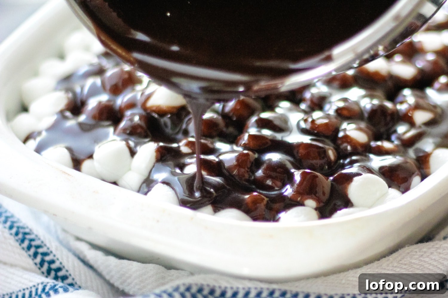 Classic Mississippi Mud Cake Recipe from Grandma's Kitchen 6 pouring chocolate frosting on mississippi mud cake