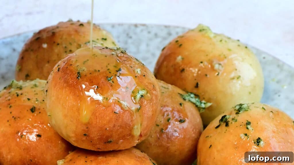 close up on dough balls with garlic butter drizzle